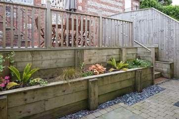 This pretty area leads from the French doors up to the fully enclosed raised terrace.