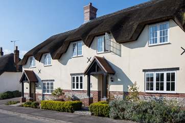 Tolpuddle is the middle cottage in the photo, the parking is behind the cottages, turn right before the white thatched cottage.