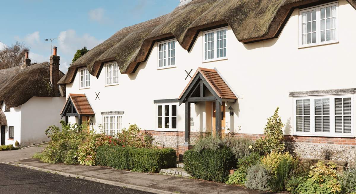 Tolpuddle is the middle cottage in the photo, the parking is behind the cottages, turn right before the white thatched cottage.