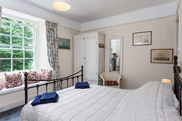 The master bedroom has a double bed, estuary views, and a fabulous en suite bathroom.