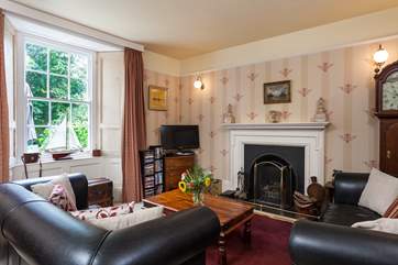 The sitting-room has a roaring open fire. Super to curl up in front of after a day out exploring St Ives.