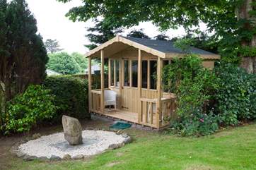 The summerhouse is located at the bottom of the rear garden, and is a gorgeous spot to read a book.
