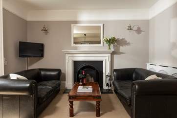 The sitting-room has a roaring open fire. Super to curl up in front of after a day out exploring St Ives.