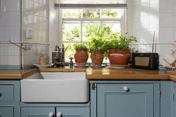 The soft blue cupboards complement the kitchen beautifully.