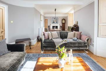 The lovely open plan sitting-dining room overlooks the terrace and gardens.