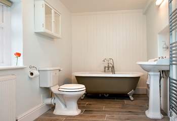 The very stylish cottage bathroom with a free-standing bath at one end....