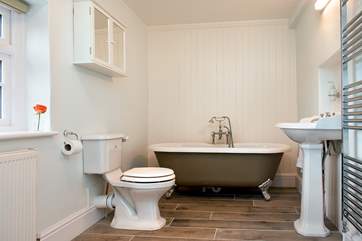 The very stylish cottage bathroom with a free-standing bath at one end....