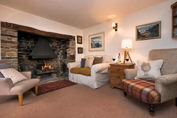 Light up the fireplace and snuggle down on the sofa with a good book in the first sitting room.