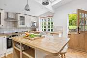 The lovely cottage kitchen is wonderfully light and airy.
