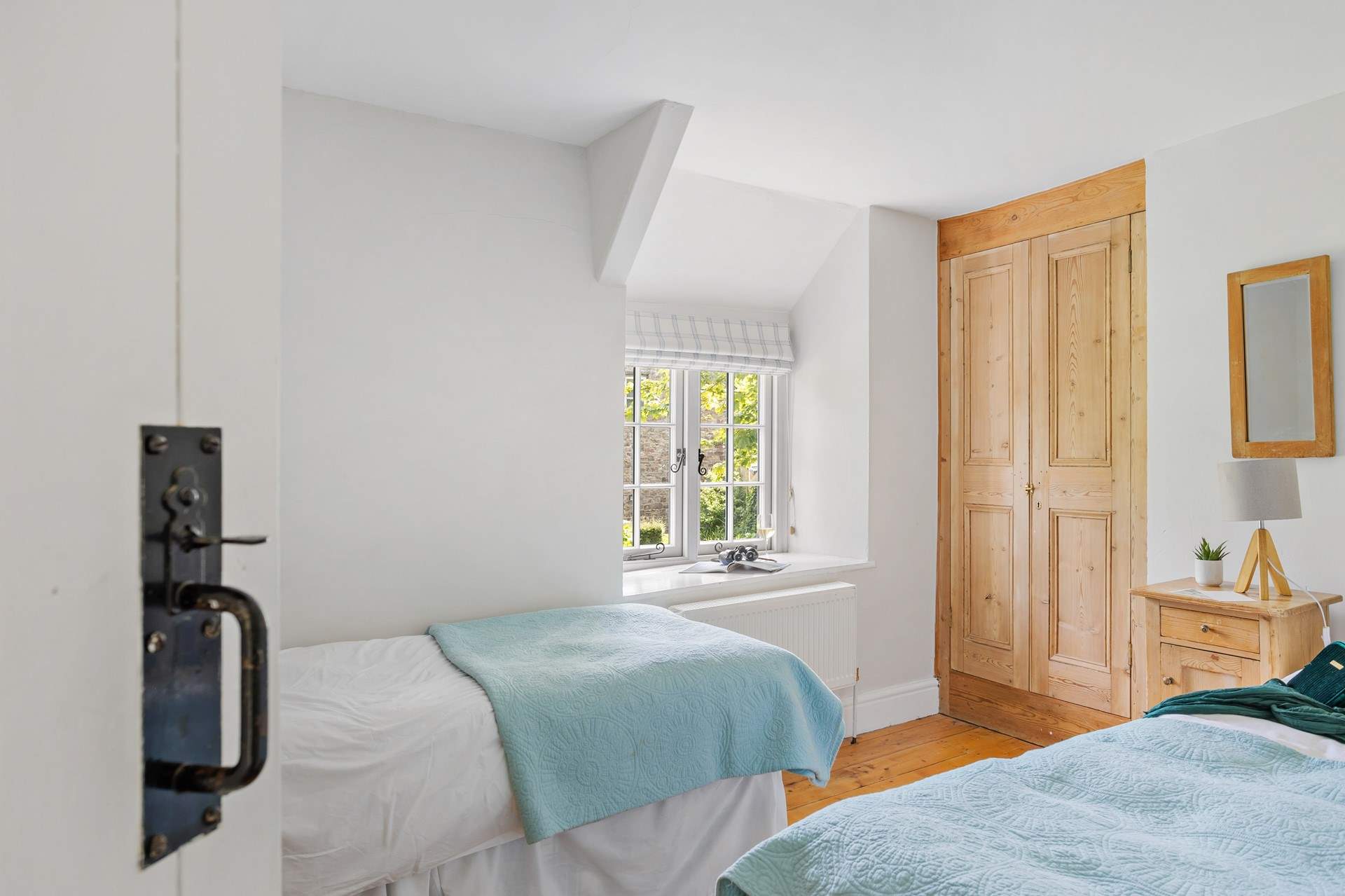 There are two cute twin rooms this one benefits from views across the front lawn and large garden.