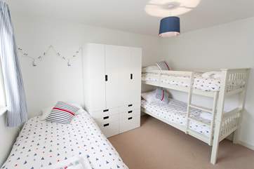 The family bedroom has bunk-beds for the younger children and a single bed for the older ones.