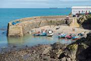 The pretty fishing harbour where you can watch the boats returning with their catch is a couple of minutes down the hill from the cottage.