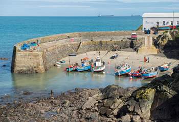 The pretty fishing harbour where you can watch the boats returning with their catch is a couple of minutes down the hill from the cottage.