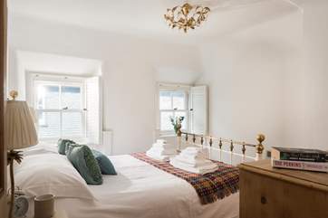 This dual-aspect bedroom with views down to the harbour and a king-size bed is next to the bathroom.