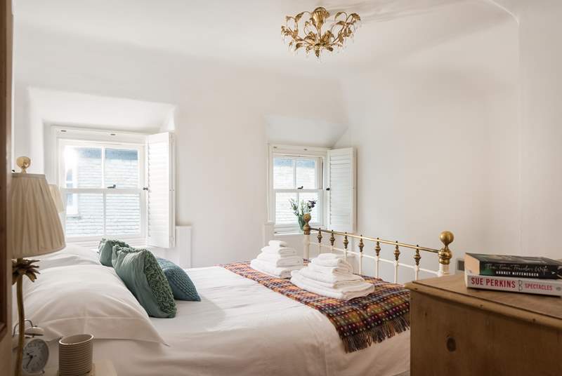 This dual-aspect bedroom with views down to the harbour and a king-size bed is next to the bathroom.