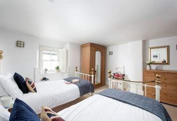 Soft linens paired with sea views in the laid-back twin room.