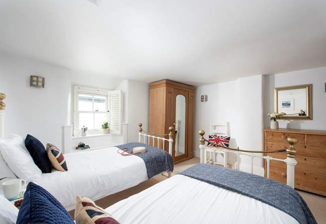 Soft linens paired with sea views in the laid-back twin room.