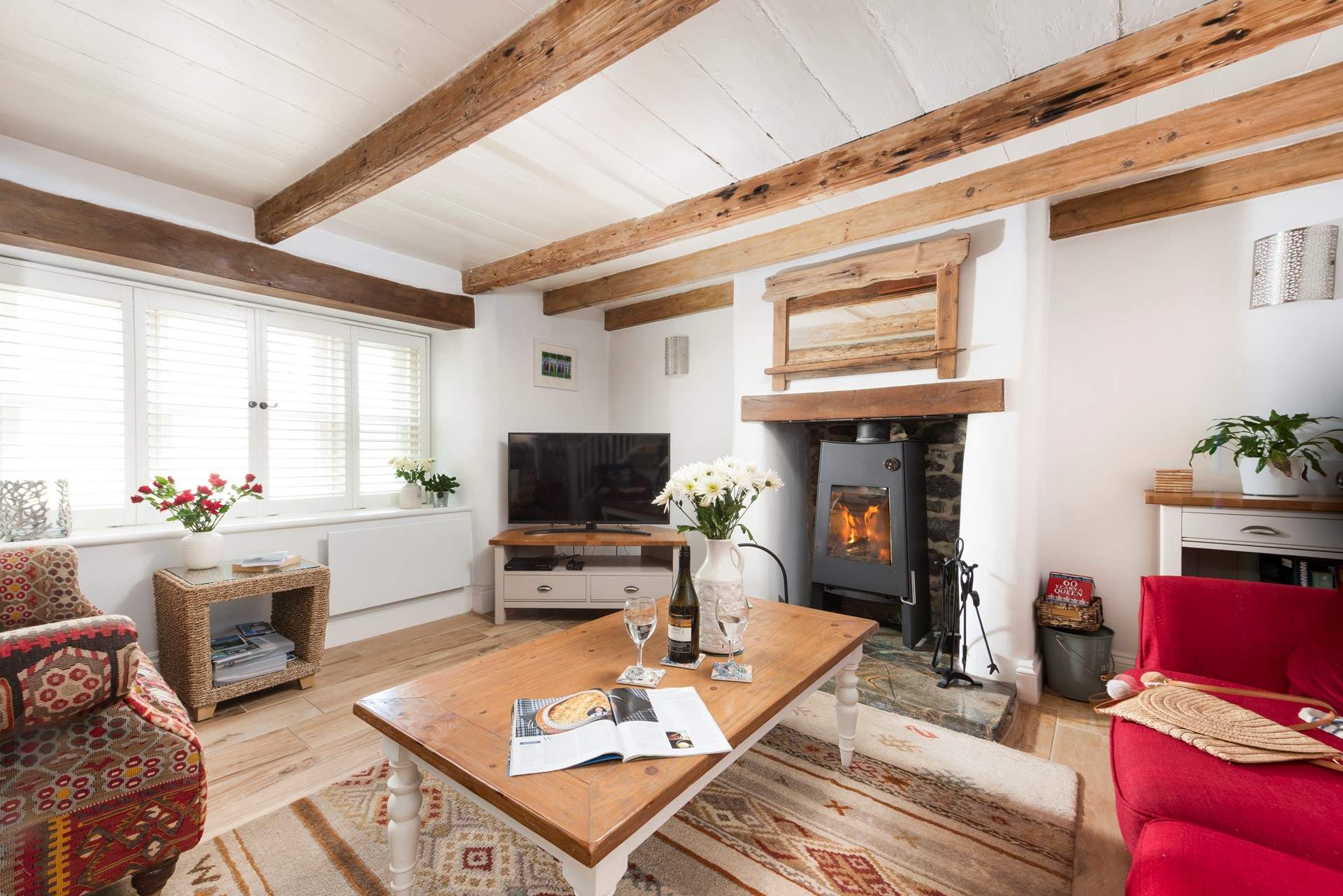 Curl up under the beams by the flickering flames.