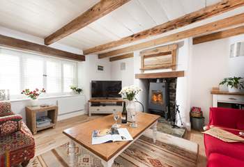 Curl up under the beams by the flickering flames.