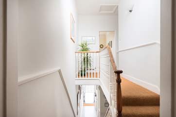 Looking down to the entrance hall, complete with original floor tiles.