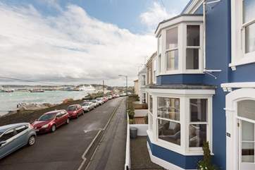 Bussillion is the dark blue house; the view stretches to the wharves on the left where naval vessels and cruise ships often moor up, to the Penryn River on the right.