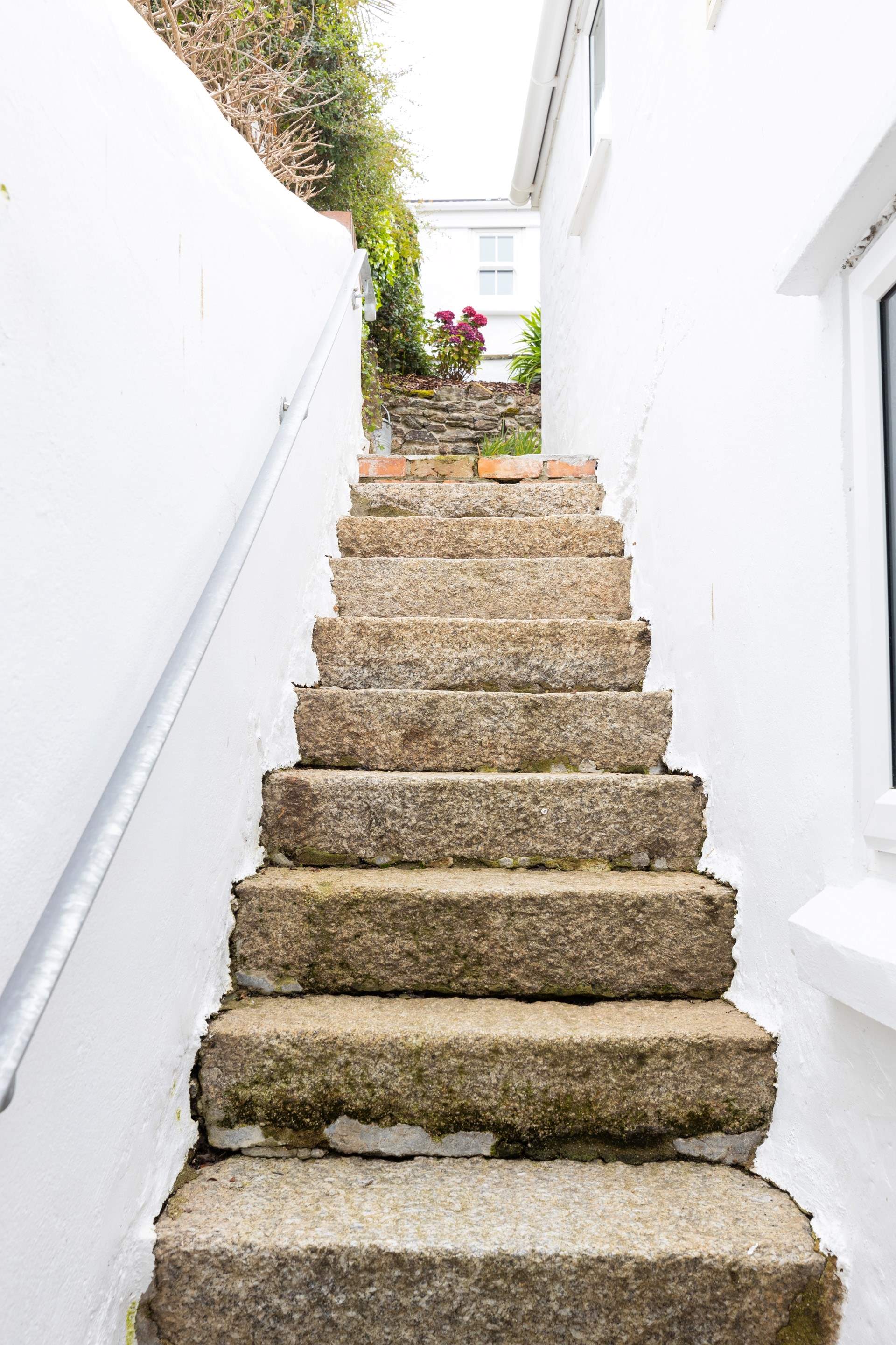 Steps from the back door lead up to the patios. 