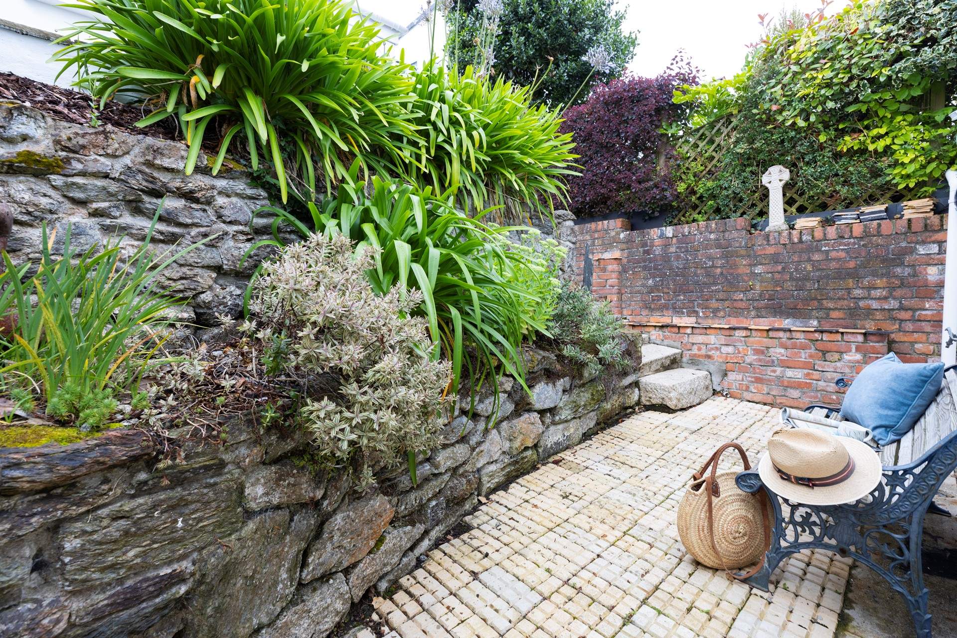 There is a little paved area on the way to the top patio, this catches the afternoon sun, just up a few more steps to the main patio. 