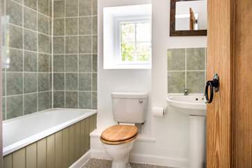 The family bathroom has a fitted shower over the bath.