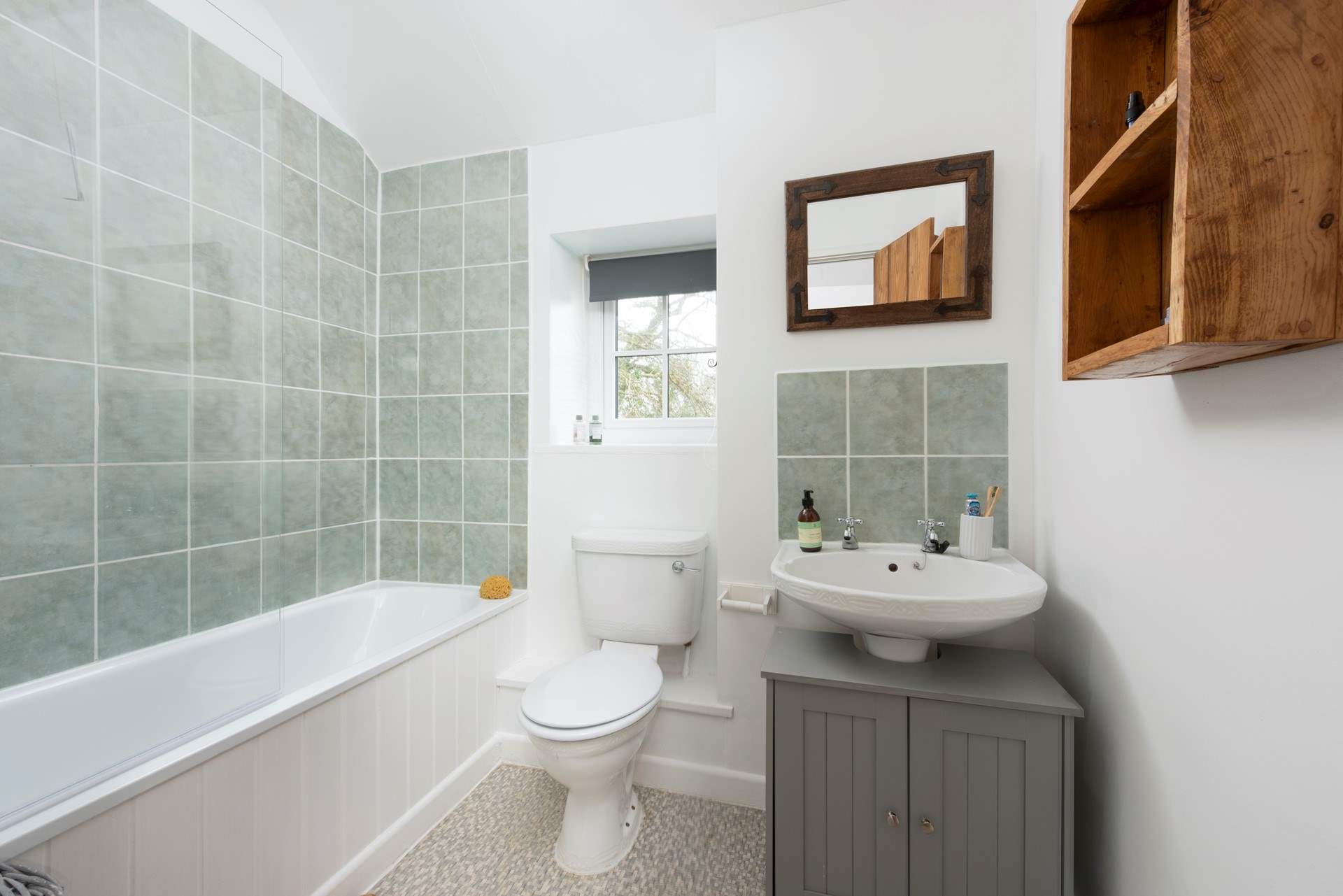 The family bathroom has a fitted shower over the bath.