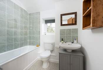 The family bathroom has a fitted shower over the bath.