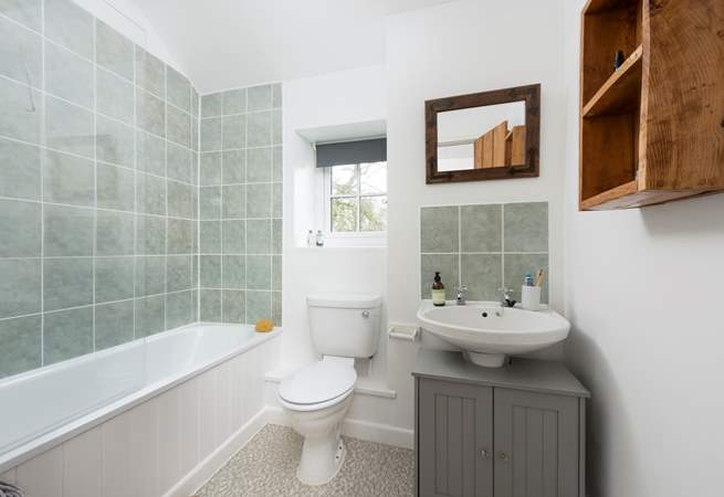 The family bathroom has a fitted shower over the bath.