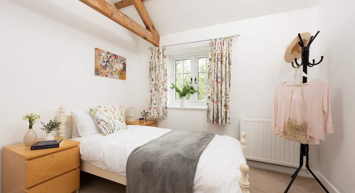 Twin beds await in the second bedroom.