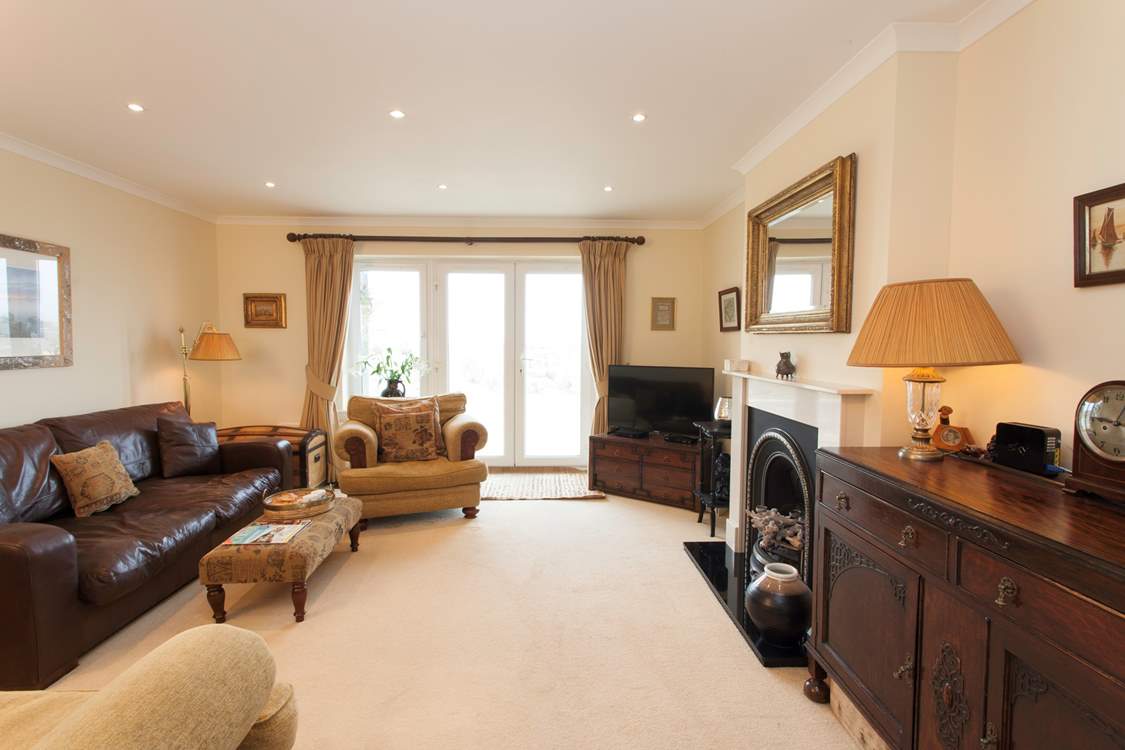 The cosy sitting-room has plenty of comfortable seating and is a lovely space to relax.