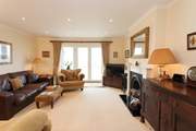 The cosy sitting-room has plenty of comfortable seating and is a lovely space to relax.