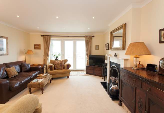 The cosy living room has plenty of comfortable seating and is a lovely space to relax