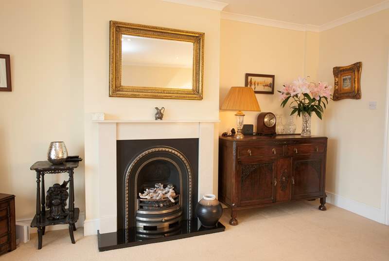 The living room has a lovely ornamental fireplace bringing character to the room