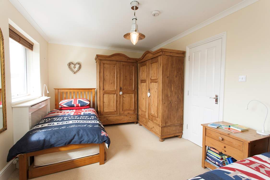 There is plenty of space in the twin bedroom looking out to the back garden and swimming pool.