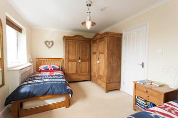 There is plenty of space in the twin bedroom looking out to the back garden and swimming pool