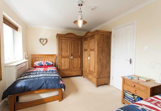There is plenty of space in the twin bedroom looking out to the back garden and swimming pool