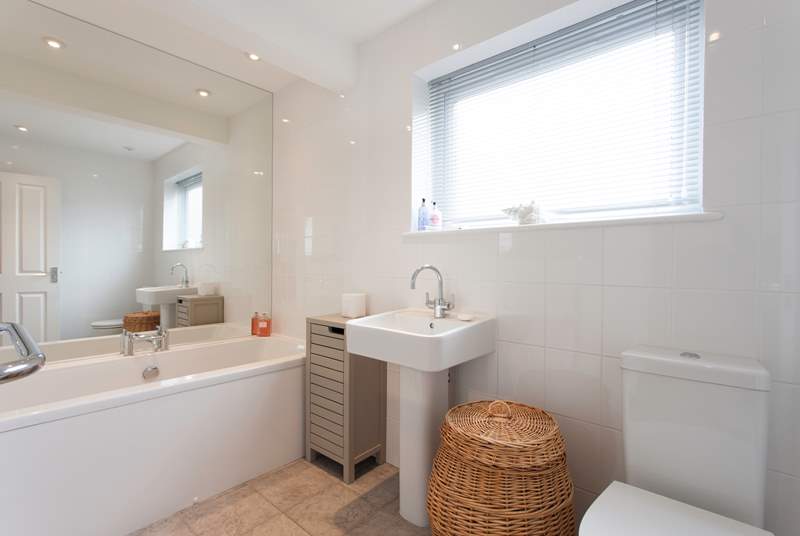 The family bathroom has plenty of room and a lovely bath to soak, relax and unwind