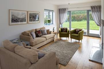 Spacious and comfortable living area which leads out onto the patio-area home to the fire-pit.