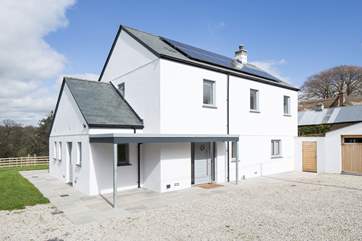 The outside of The Orchard, with large gated gravelled parking area.