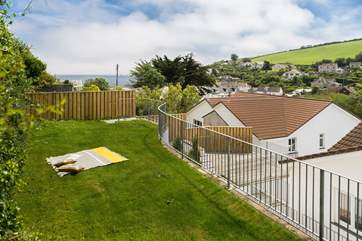 The raised lawn area has views of the sea.