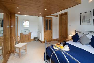 The master bedroom with en suite WC, and a wash-basin and shower cubicle situated in the far left corner of the room.