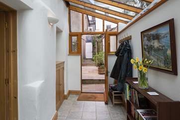 The spacious entrance hall is the perfect spot to dump the boots, bags and coats after a day of exploring. The white door is the access to the passageway out to High Street, this door is access only