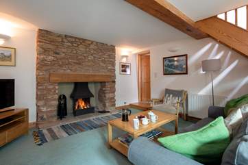 This inviting and comfortable living-area with an open fire is perfect for those cosy nights in.