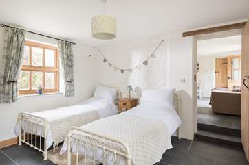 A couple of steps lead down to Bedroom 2, at one end of the cottage, with twin beds.