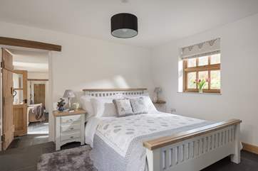 Three steps leads up to the beautiful master bedroom which has the most gorgeous linens and soft furnishings.
