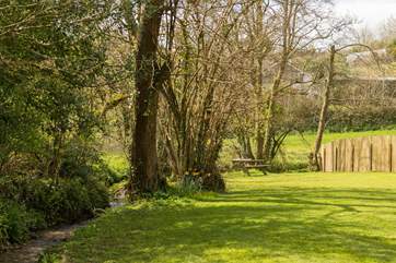 The level lawn adjoins the little stream.