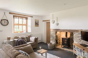 The wood-burner sits in an original inglenook fireplace.